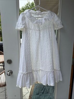 Pure white all-over eyelet cotton broderie anglaise rounded bib collar ruffles